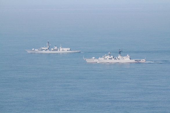 HMS St Albans (background) monitors the Russian frigate Yaroslav Mudry in the English Channel