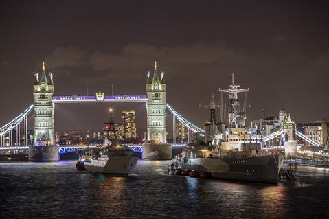 HMS Tyne sailing under Tower Bridge in London
