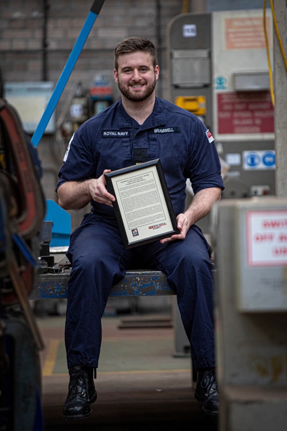 Engineering Technician Sean Bramwell with his recognition award for his efforts during the COVID response