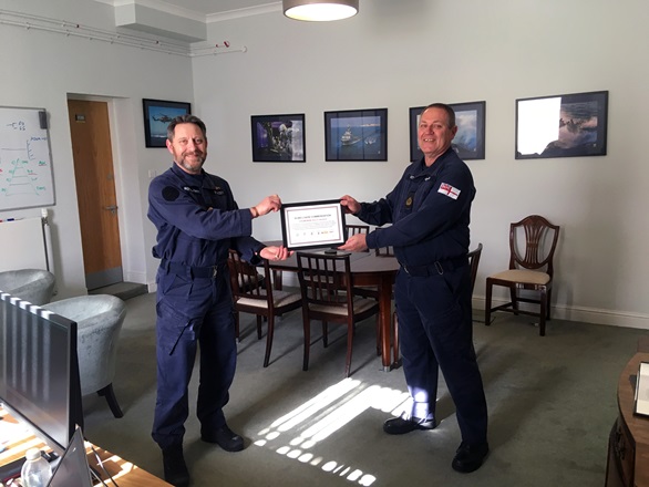 FOST Cdre Andrew Stacey (left) presents CPO Kevin Hewson with his certificate