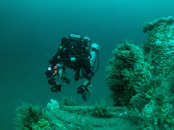 One of the dive team moves around the heavily-encrusted wreck