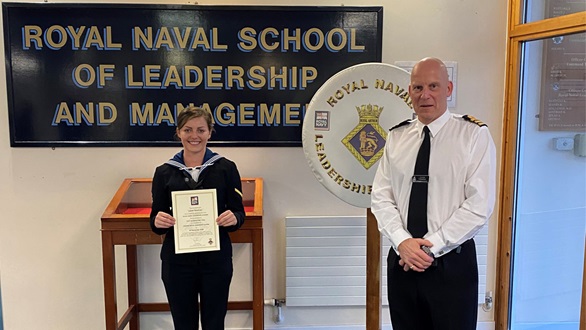 Able Seaman Henrietta Goodrum recieves certificate from her father Commander Simon Goodrum