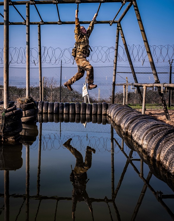 A Royal Marine recruit tackles the assault course at Lympstone