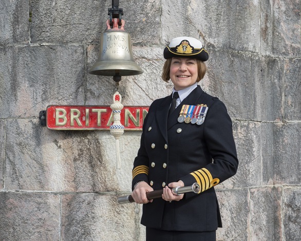 BRNC's new CO Captain Sarah Oakley in front of the college's famous bell