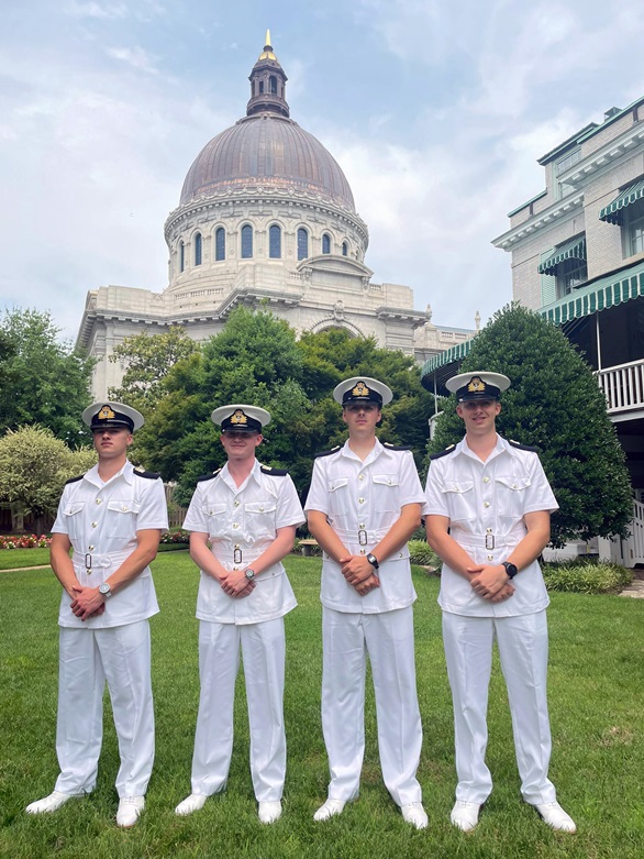 L-r Midshipmen Ben Allen Henry Francis Alexander Tolley Nathan Hayes and the iconic naval academy chapel